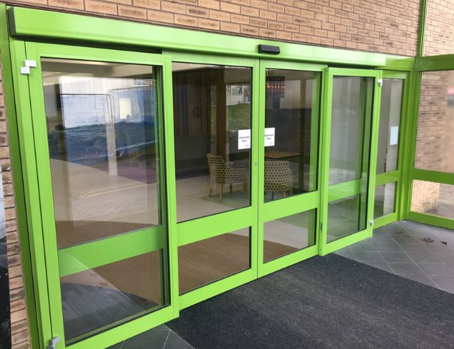 Automatic door shopfronts UK installed at a modern commercial building entrance with sliding glass doors